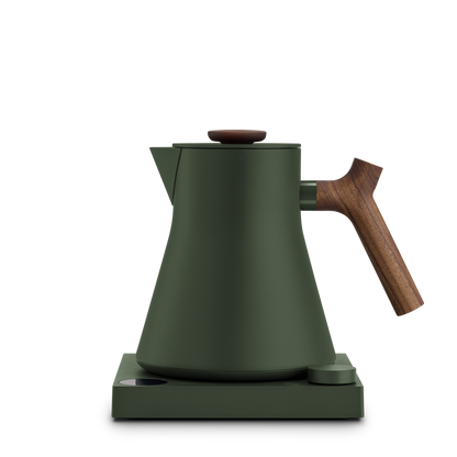 Fellow Corvo EKG Woodland + Walnut electric kettle with wooden handle on matching base.